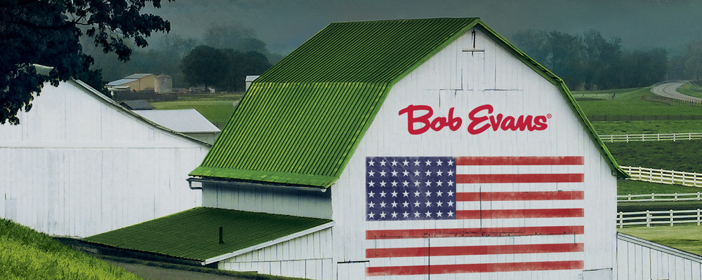 Official Bob Evans Veterans Day event banner showing its barn, logo and an American flag.