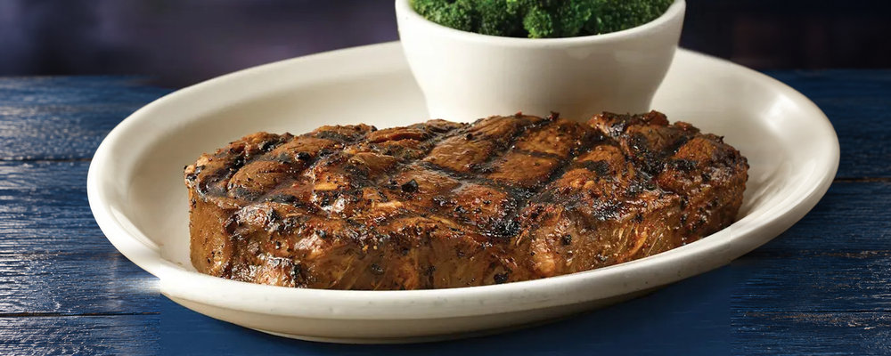 A Bubba's 33 ribeye plate with a side of broccoli