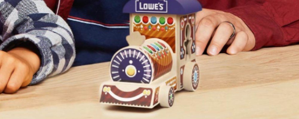 A finished Lowe's Holiday Engine wooden toy train on a workbench