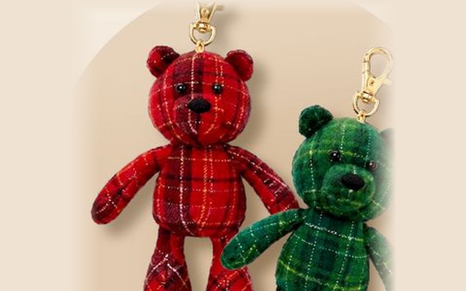 Two plaid bear keychains, one red and one green, with gold clasps
